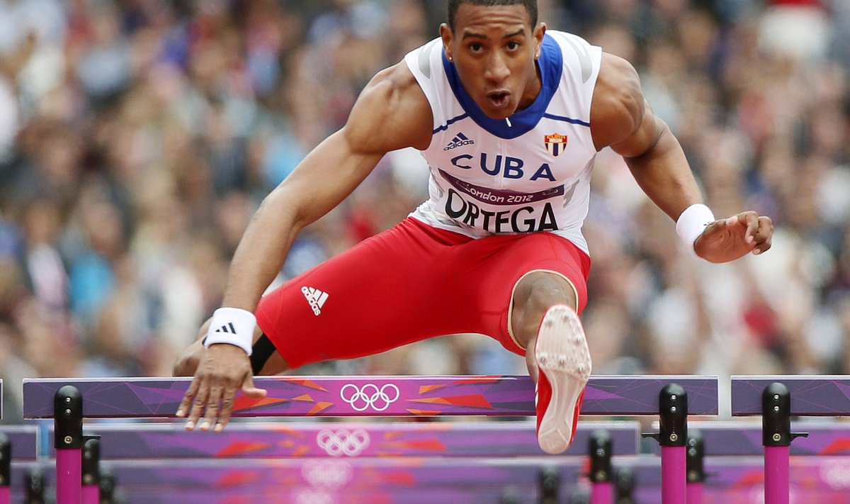 Cuba's Orlando Ortega clears a hurdle during his men's 110m hurdles round 1 heat at the London 2012 Olympic Games at the Olympic Stadium