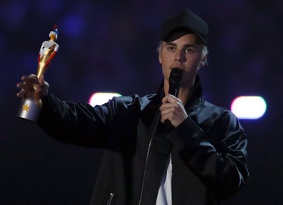 Justin Bieber accepts the award for best international male artist at the BRIT Awards at the O2 arena in London