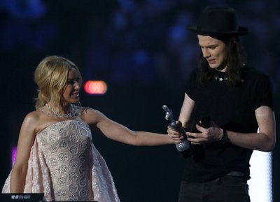 James Bay accepts the award for best British male solo artist from Kylie Minogue at the BRIT Awards at the O2 arena in London