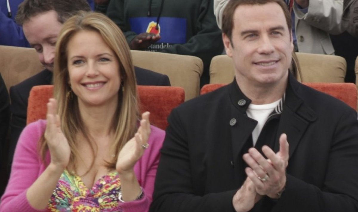 John Travolta and his wife Kelly Preston, left, during a visit to the  Nelson Mandela Children's Fund headquarters in Johannesburg, Saturday, June 12, 2010. Travolta is in the country for five days a s an official goodwill ambassador for the Australian soccer team. (AP Photo/Denis Farrell) / SCANPIX Code: 436
