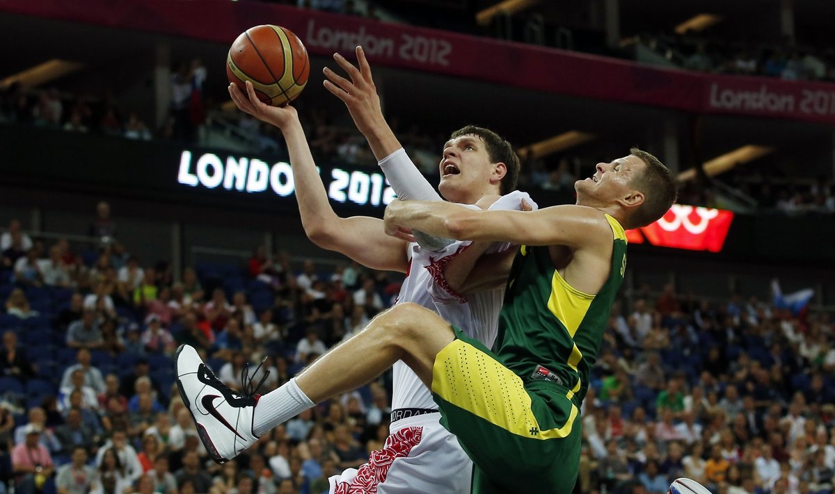 Russia's Mozgov is guarded by Lithuania's Seibutis during their men's quarterfinal basketball match at the North Greenwich Arena in London during the London 2012 Olympic Games