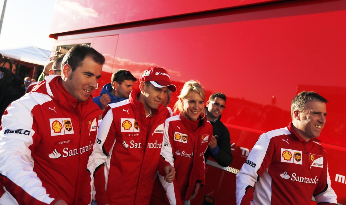 Ferrari F1 driver Sebastian Vettel of Germany walks with members of his team in the paddock at the Jerez racetrack in southern Spain