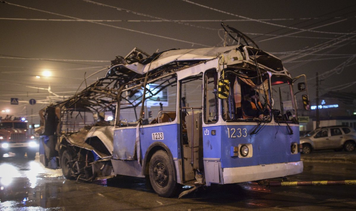 A bus, destroyed in an earlier explosion, is towed away in Volgograd