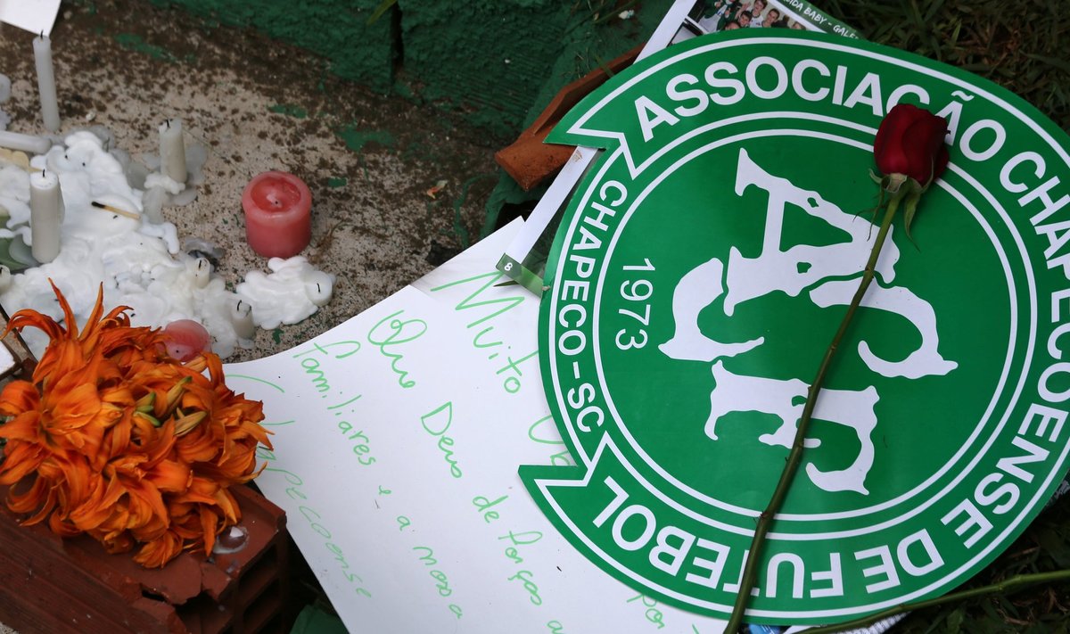 Flowers and messages are seen next a Chapecoense soccer team flag in tribute to their players in front of the Arena Conda stadium in Chapeco