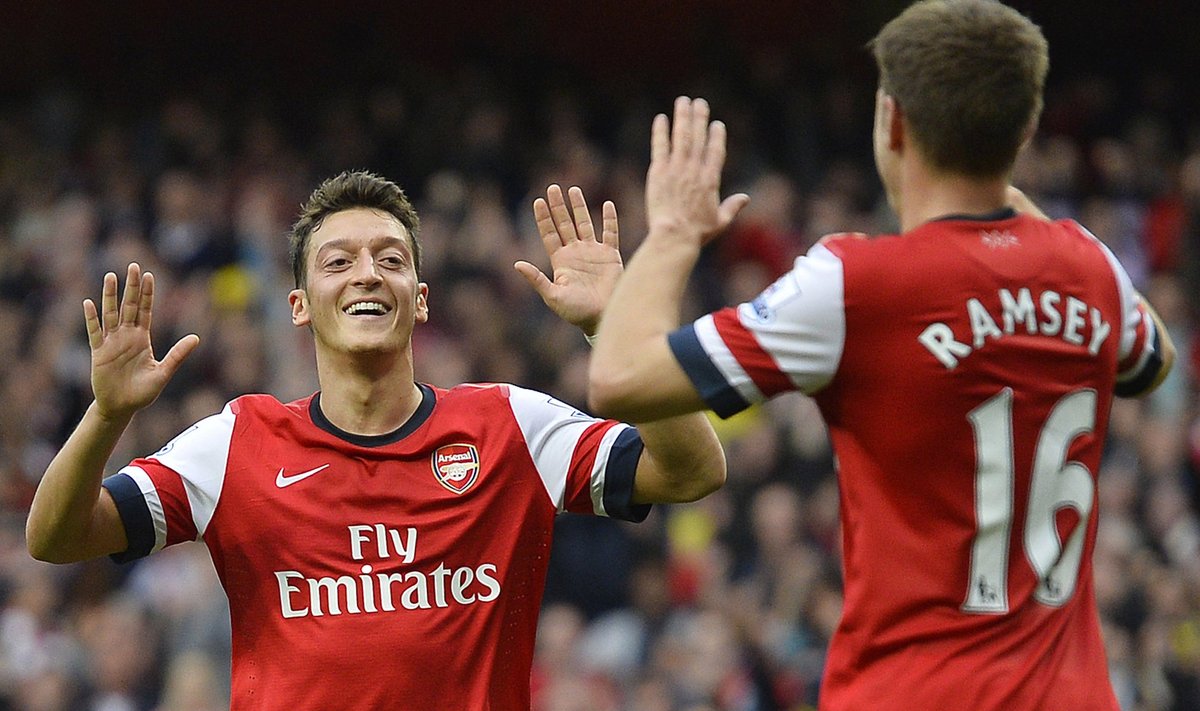 Arsenal's Ozil celebrates scoring his second goal against Norwich City with team-mate Ramsey during their English Premier League soccer match in London