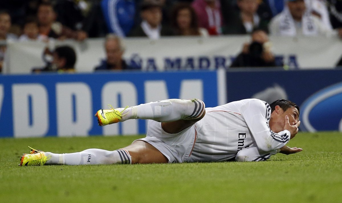 Real Madrid's Ronaldo reacts after being fouled by Juventus' Chiellini during their Champions League soccer match in Madrid