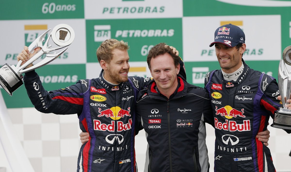 Sebastian Vettel of Germany, Christian Horner and Mark Webber of Australia celebrate their overall team win at the the Brazilian F1 Grand Prix at the Interlagos circuit in Sao Paulo