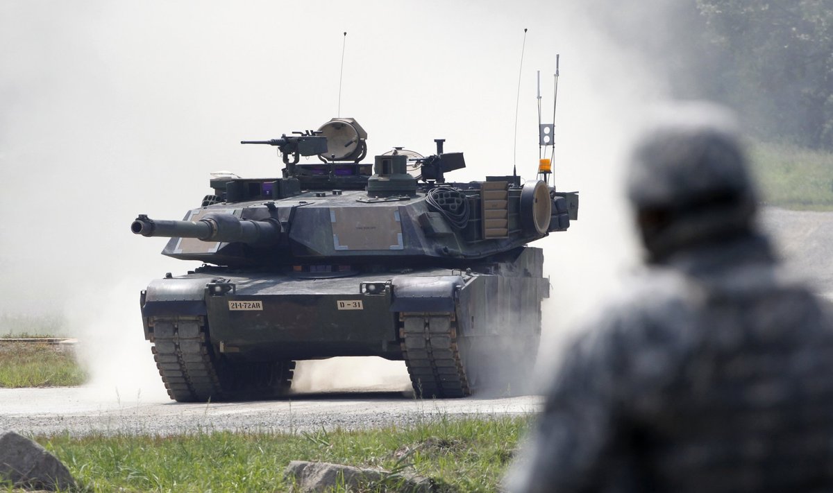 A U.S. soldier looks at a M1A2 SEP Abrams battle tank during a joint military exercise between South Korea and the U.S. in Pocheon