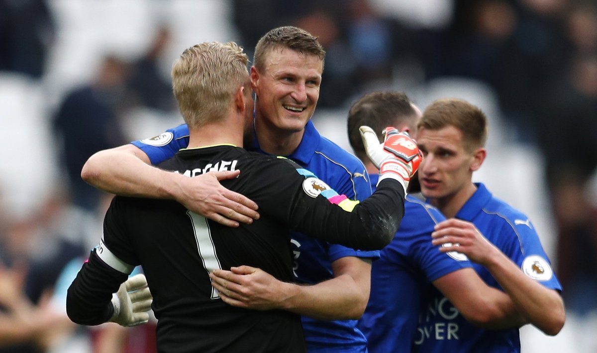 Leicester City's Kasper Schmeichel and Robert Huth celebrate at the end of the game