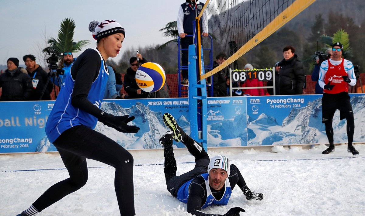 Giba Godoy of Brazil falls as Kim Yeon-Koung of South Korea save a point during an event promoting the Snow Volleyball hosted by FIVB and CEV in Pyeongchang