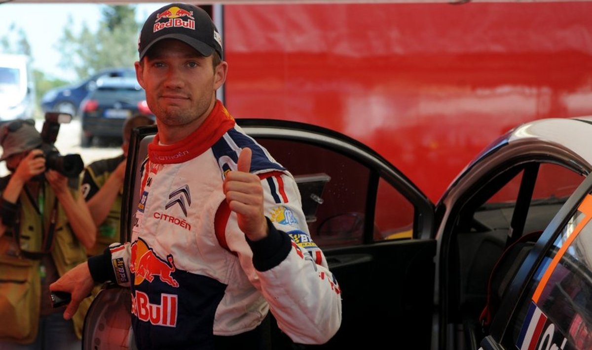 Sebastien Ogier of France gives the thumbs up to the fans as he steps out of his Citroen C4 before the last stage super-special of the Portugal WRC Rally at Algarve Stadium on May 30, 2010 in Faro. Ogier leads with a 7.7 seconds over compatriot Sebastien Loeb.  AFP PHOTO/ FRANCISCO LEONG
