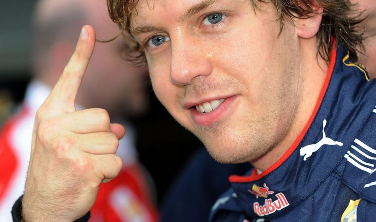 Red Bull Racing's Sebastian Vettel of Germany gestures 'number one' after setting the fastest time during the qualifying session for Formula One's Australian Grand Prix in Melbourne on March 27, 2010.  Vettel will start from pole position on the grid for the Australian Grand Prix on March 28.  AFP PHOTO / Torsten BLACKWOOD