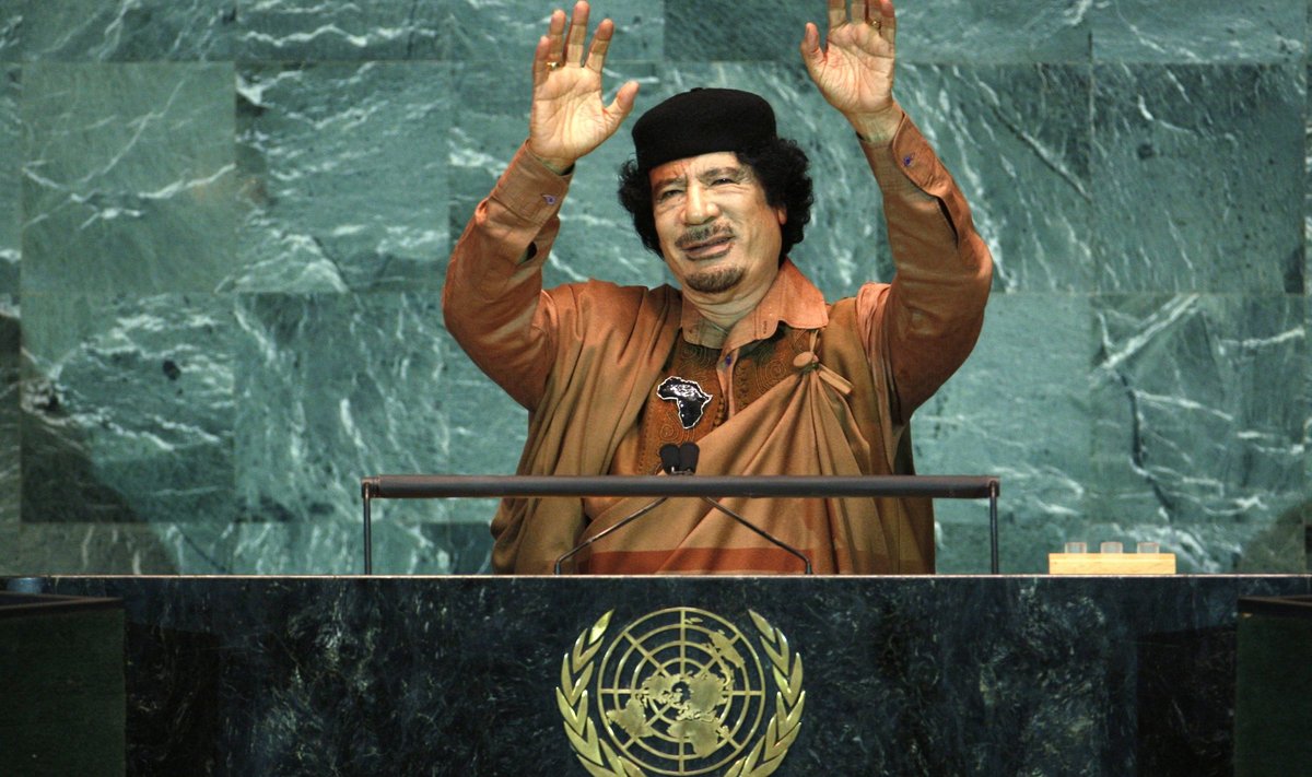 Libyan leader Muammar Gaddafi raises his arms during his address at the 64th United Nations General Assembly at U.N.headquarters in New York
