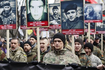 Activists of the Right Sector political party carry portraits of their comrades killed in fighting with pro-Russian separatists during an anti-government march in Kiev