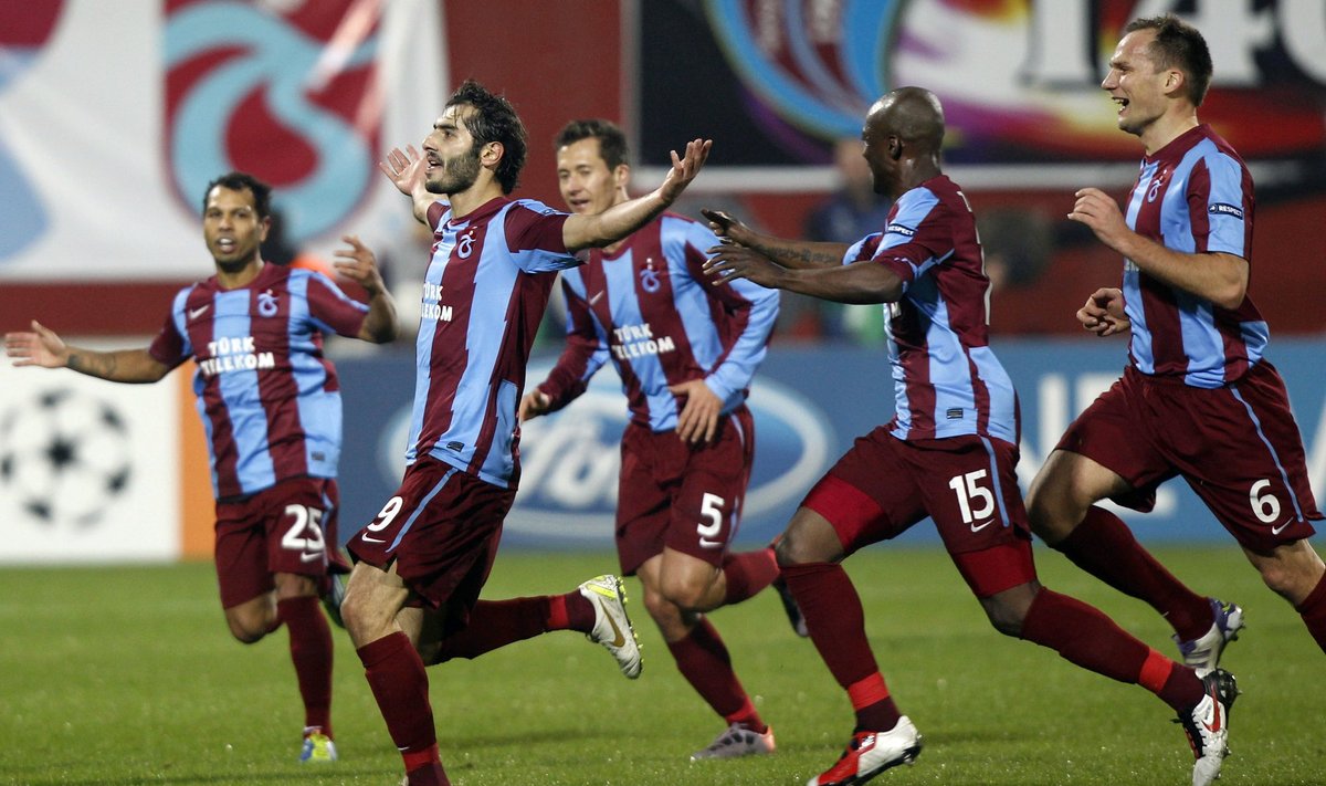 Trabzonspor's Halil Altintop celebrates with his team mates after scoring a goal against Inter Milan during their Champions League soccer match in Trabzon