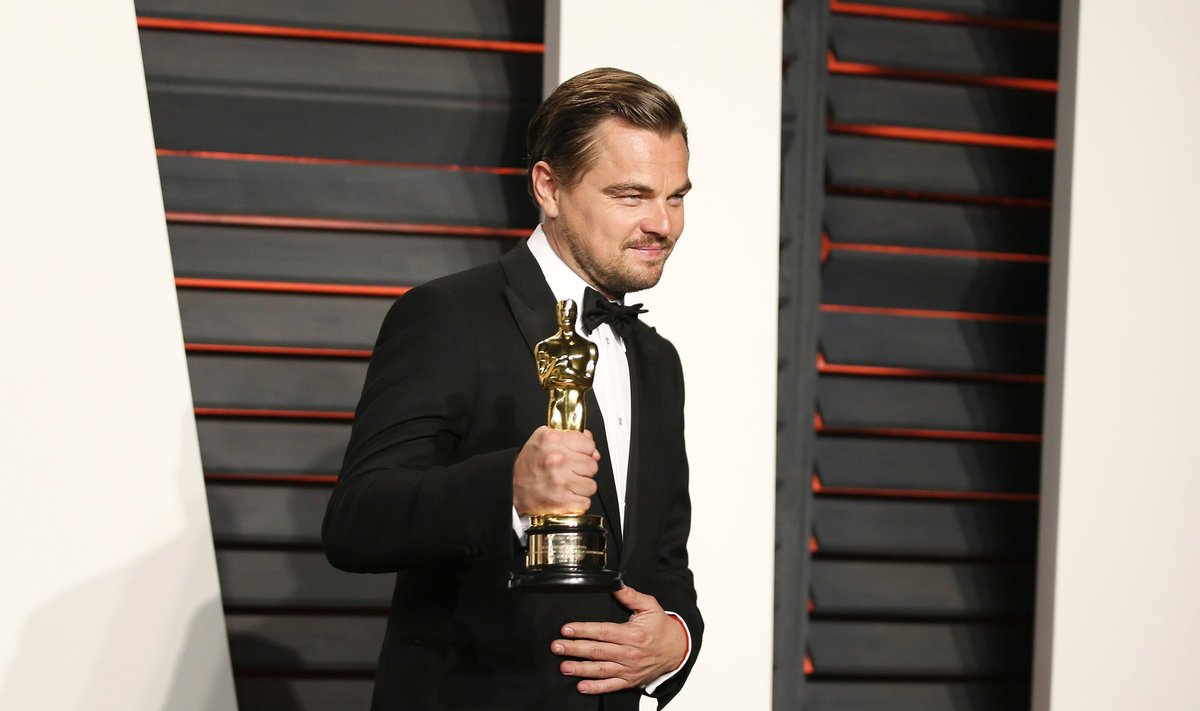 Leonardo DiCaprio holds his Best Actor award during the Vanity Fair Oscar Party in Beverly Hills