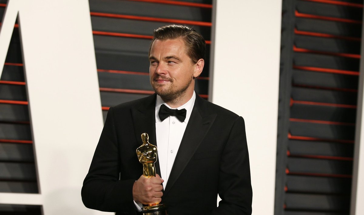 Leonardo DiCaprio holds his Best Actor award during the Vanity Fair Oscar Party in Beverly Hills