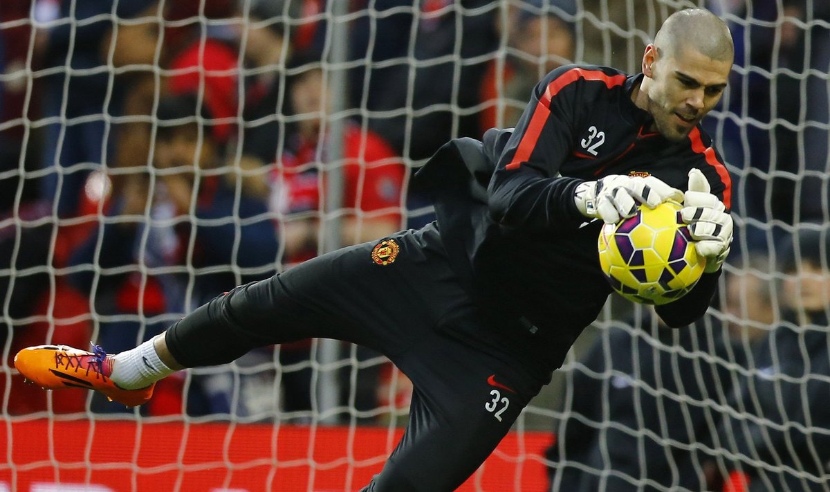 Manchester United's new number two goalkeeper Victor Valdes warms up before their English Premier League soccer match against Southampton at Old Trafford in Manchester