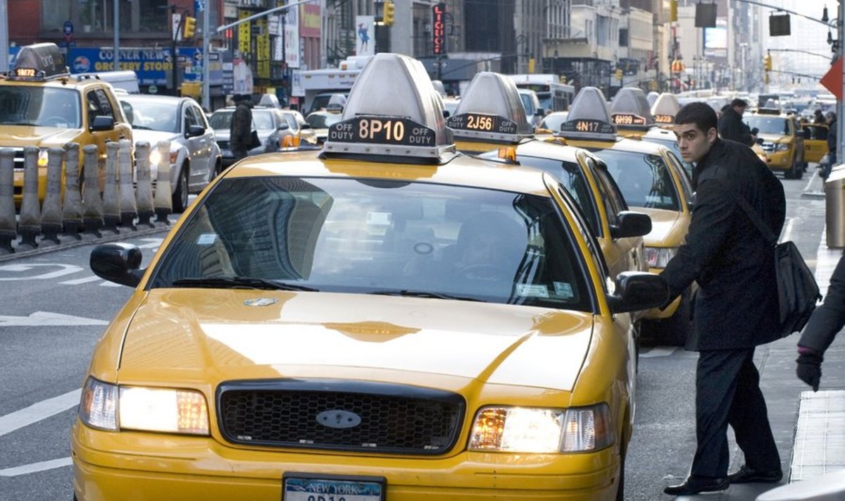 A man gets into a cab outside the Port Authority Bus Terminal January 12, 2010 in New York. There are about 13,000 "Medallion taxis," (those with an aluminum plaque bolted to the hood of the cab) in New York City. AFP PHOTO/DON EMMERT