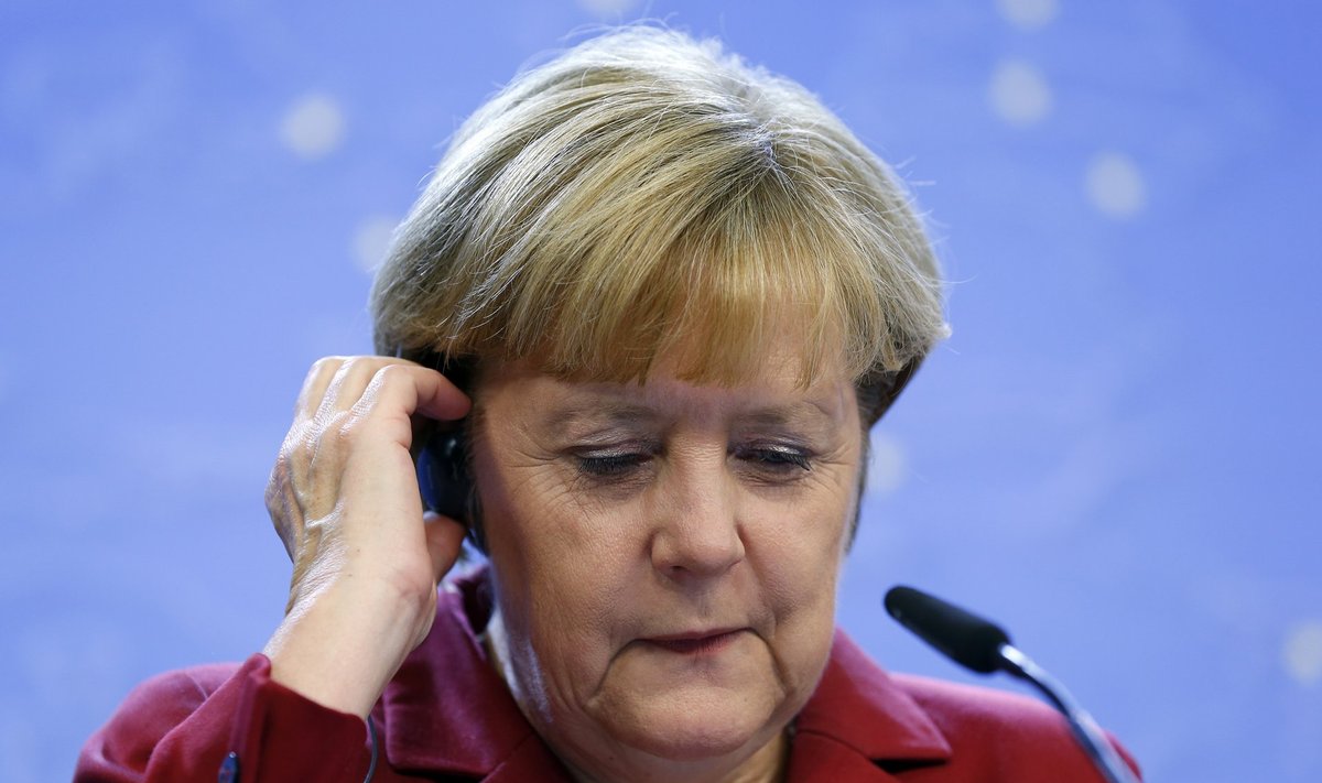 Germany's Chancellor Angela Merkel adjusts her headset during a news conference at a European Union leaders summit in Brussels