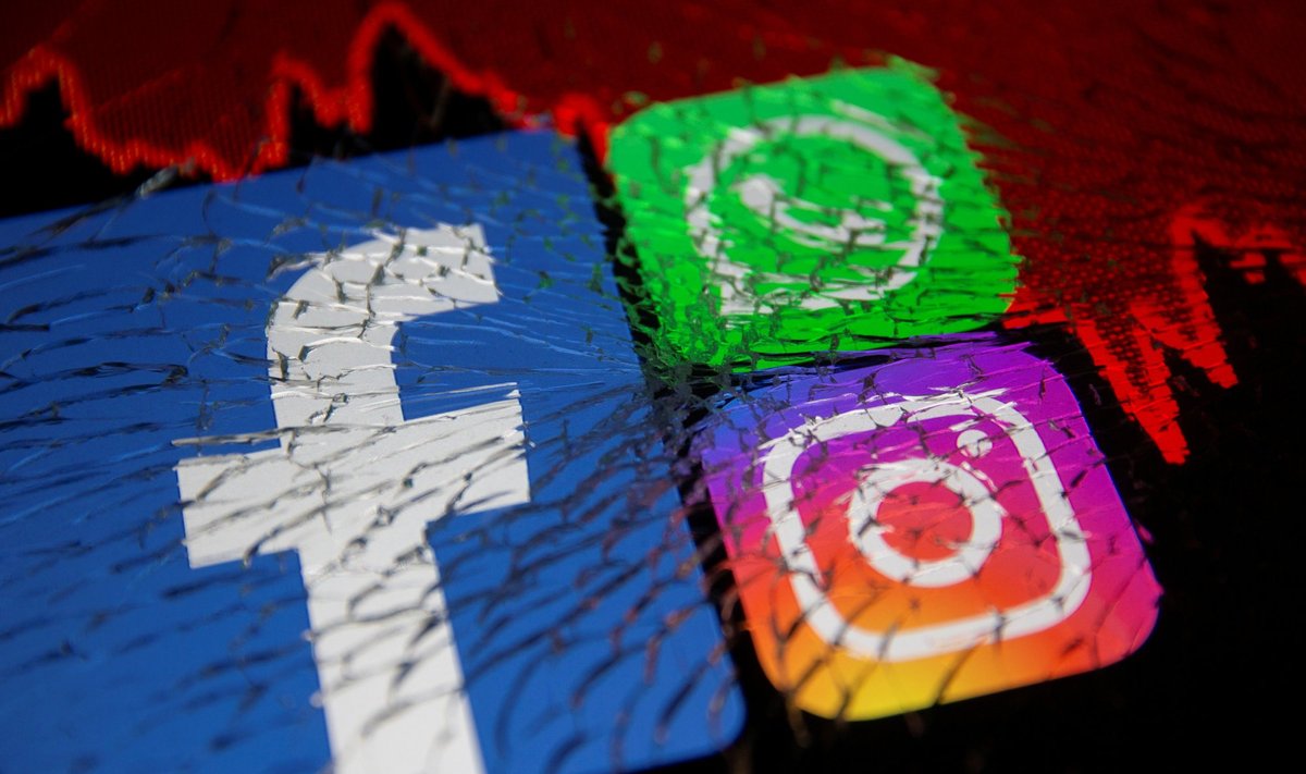 FILE PHOTO: Facebook, Whatsapp and Instagram logos and stock graph are displayed through broken glass in this illustration