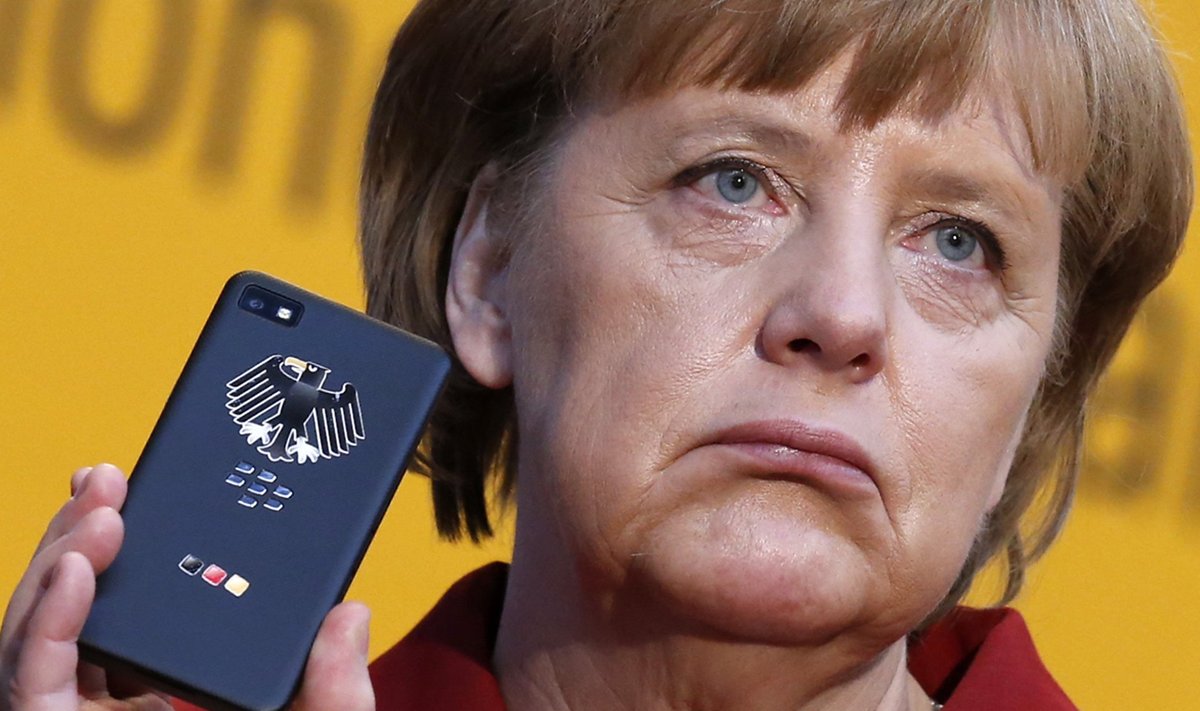 File photo of German Chancellor Merkel holding a smartphone featuring high security Secusite software in Hanover