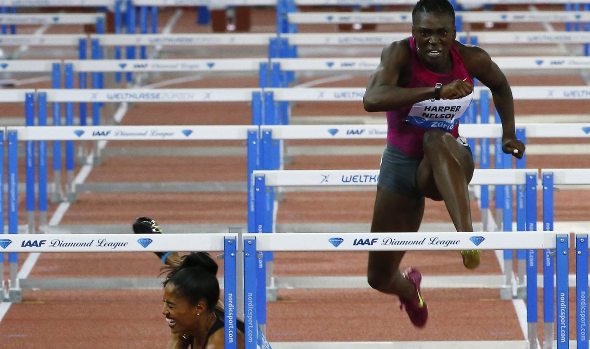 Harrison of the U.S. falls next to compatriot Harper-Nelson during the women's 100m hurdles event of the Weltklasse Diamond League meeting at the Letzigrund stadium in Zurich