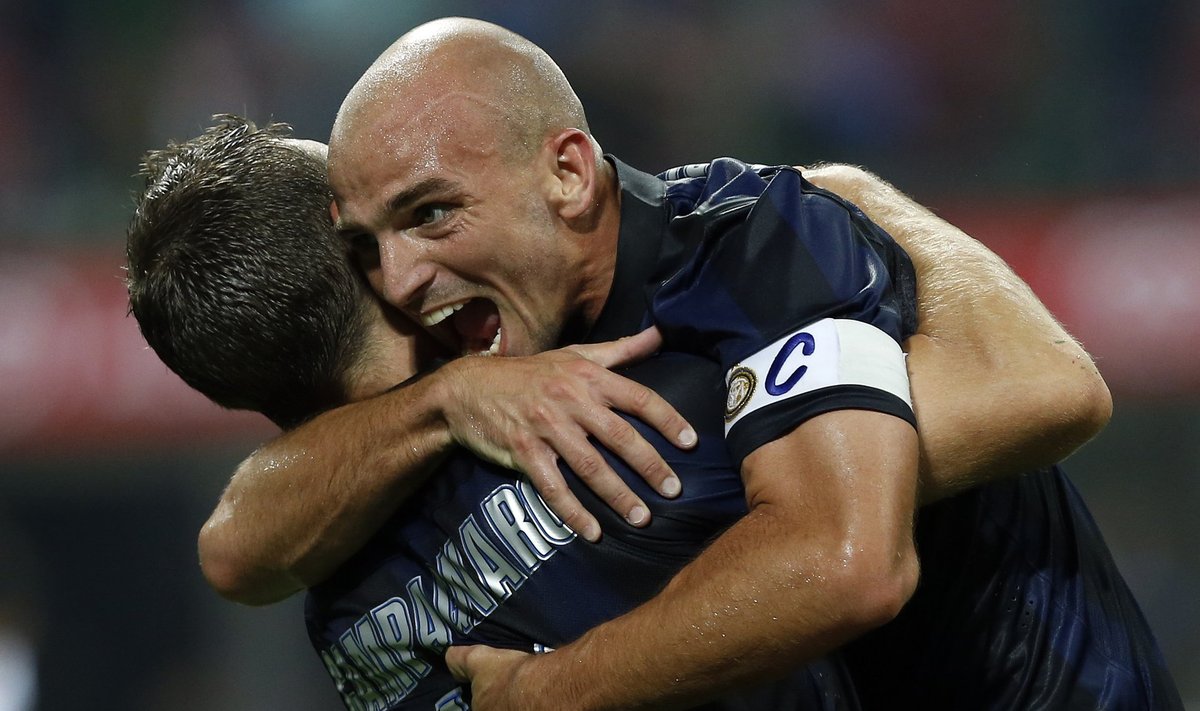Inter Milan's Cambiasso celebrates with team mate Campagnaro at the end of their Italian Serie A match against Fiorentina in Milan