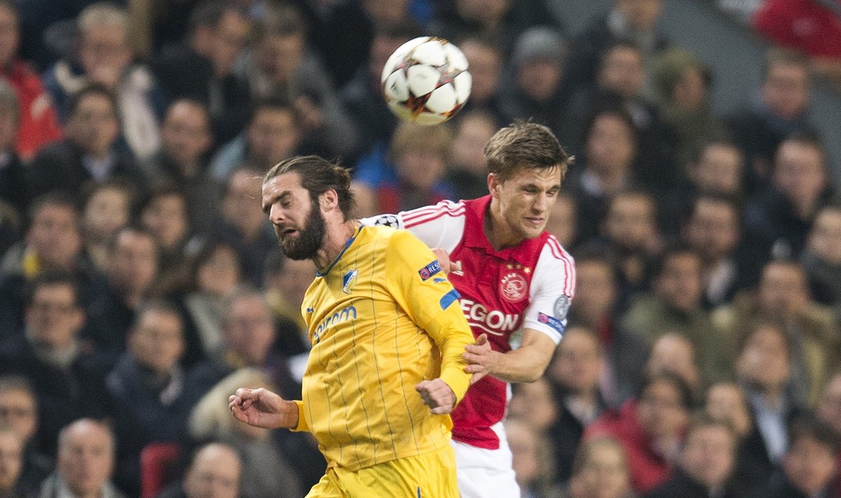 APOEL Nicosia's Sheridan challenges Veltman of Ajax Amsterdam during their Champions League soccer match in Amsterdam