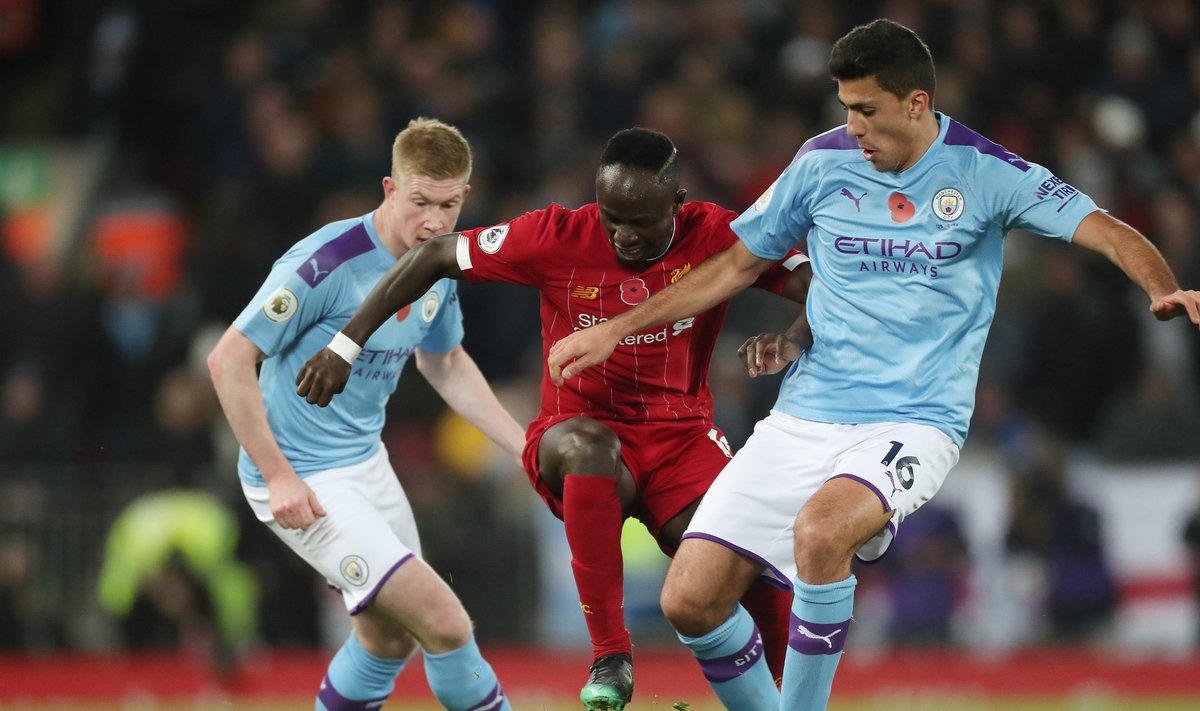Football - 2019 / 2020 Premier League - Liverpool vs. Manchester City Sadio Mane of Liverpool competes with Rodri of Ma