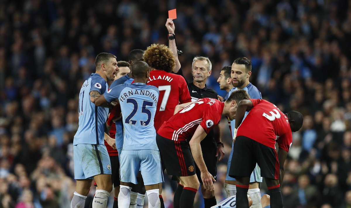 Manchester United's Marouane Fellaini is shown a red card by referee Martin Atkinson