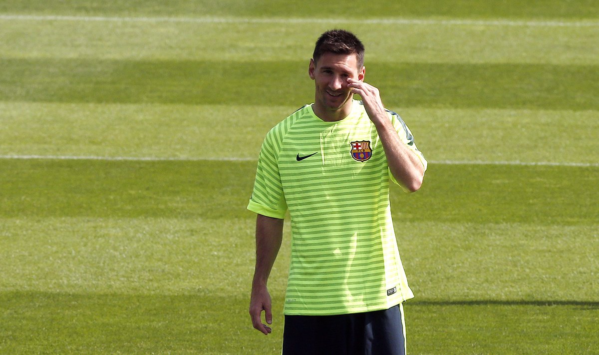 Barcelona's Lionel Messi gestures during their training session on the eve of their Champions League match against Apoel FC at Ciutat Esportiva Joan Gamper training grounds in Sant Joa Despi near Barcelona