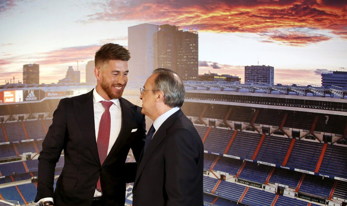 Real Madrid's Spain defender Sergio Ramos embraces Real Madrid president Florentino Perez at Santiago Bernabeu stadium in Madrid
