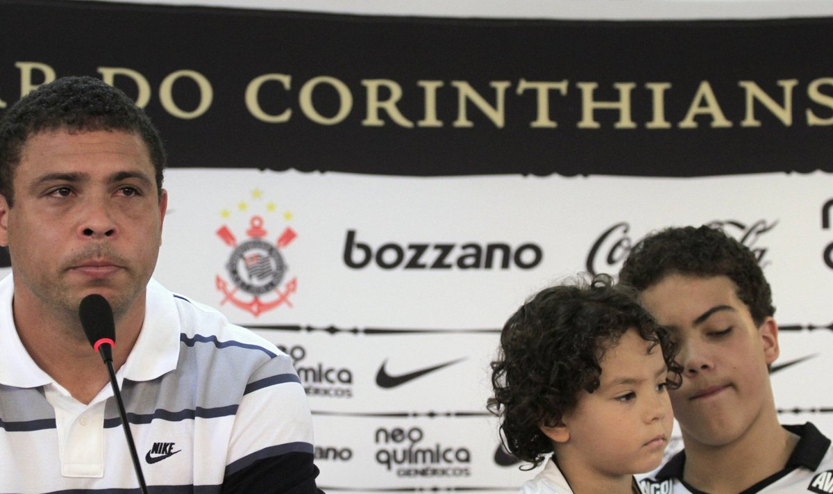 Former Brazil striker Ronaldo talks next to his sons during a news conference in Sao Paulo