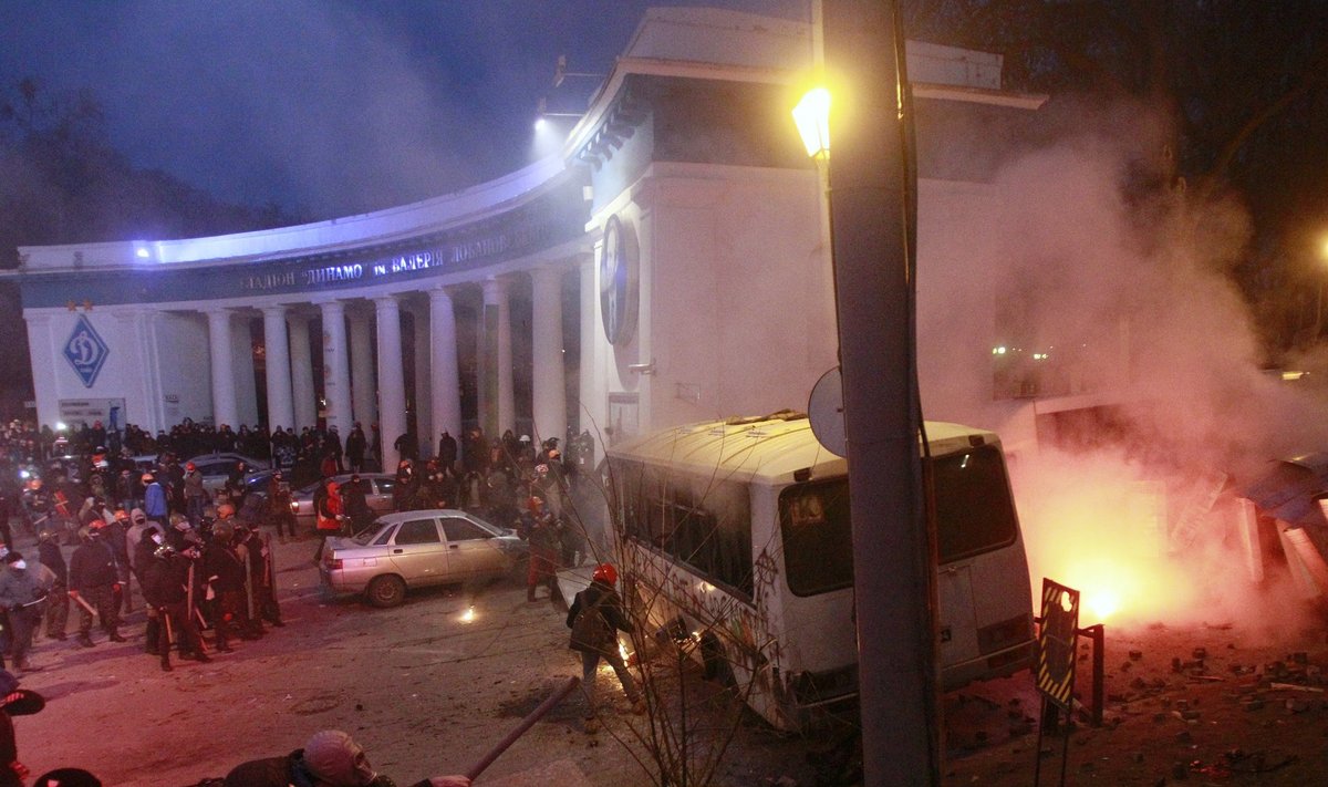 A police van burns after being attacked by Pro-European integration protesters during a rally near government administration buildings in Kiev