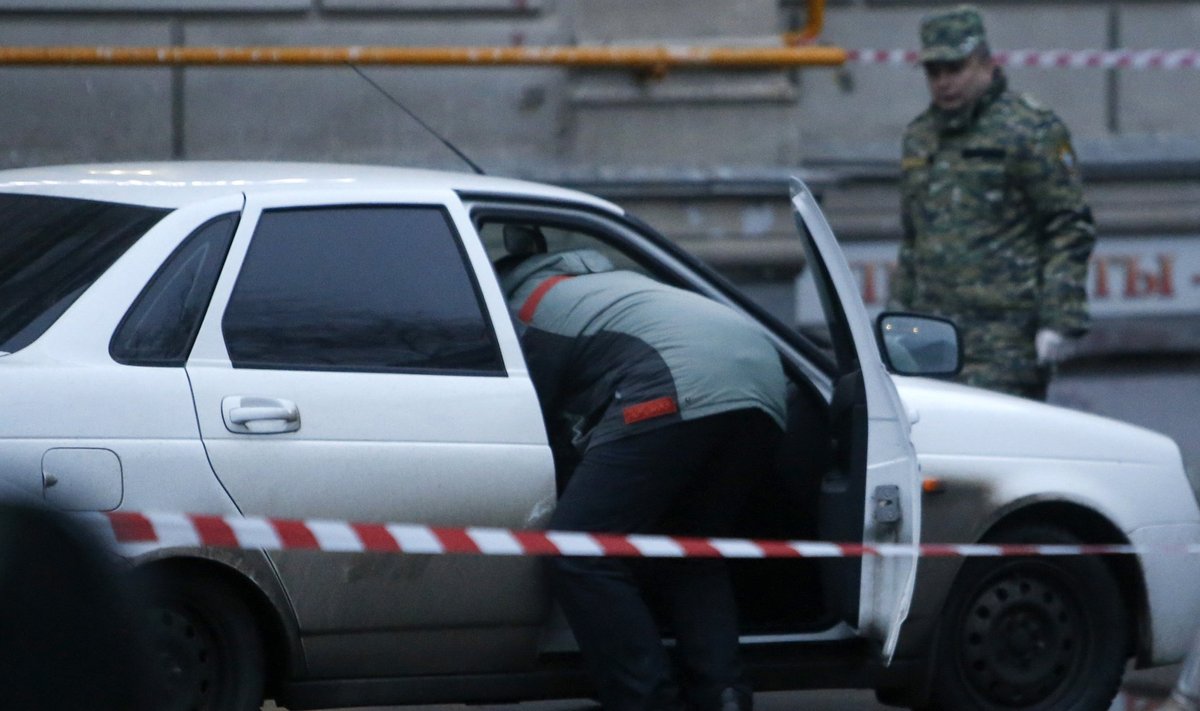 An investigator looks inside a suspicious car in Moscow