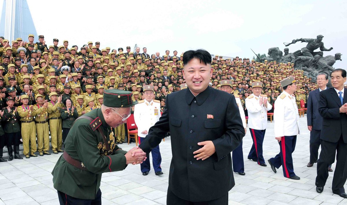 KCNA picture shows North Korean leader Kim Jong-Un shaking hands during a photo session with war veteran delegates who took part in the celebrations of the 60th anniversary of the signing of the truce of the Korean War