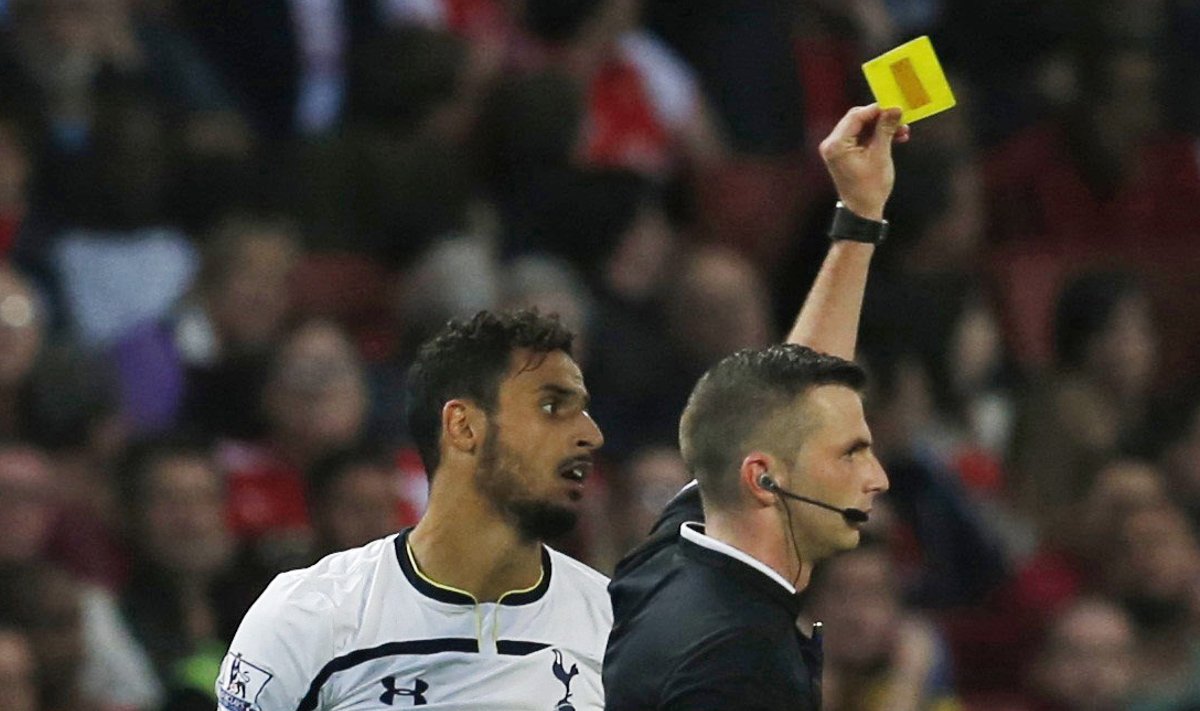 Tottenham Hotspur's Nacer Chadli is shown the yellow card for excessive celebration by match referee Michael Oliver during their English Premier League soccer match against Arsenal in London