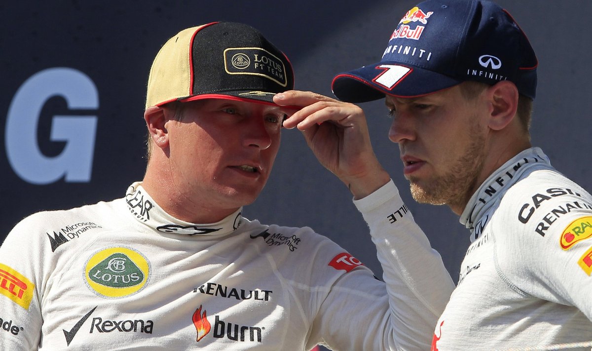 Lotus F1 driver Raikkonen talks to Red Bull driver Vettel on the podium after the Hungarian F1 Grand Prix in Mogyorod
