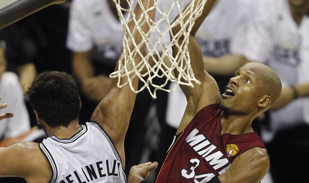 Miami Heat's Ray Allen goes up to score past San Antonio Spurs' Marco Belinelli of Italy during the second half in Game 1 of their NBA Finals basketball series in San Antonio