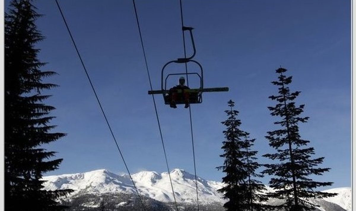 Switzerland's Simon Ammann sits in a chair lift prior to  an official practicing session for the Men's large hill individual ski jumping at the Vancouver 2010 Olympics in Whistler, British Columbia, Canada, Wednesday, Feb. 17, 2010. (AP Photo/Matthias Schrader) / SCANPIX Code: 436