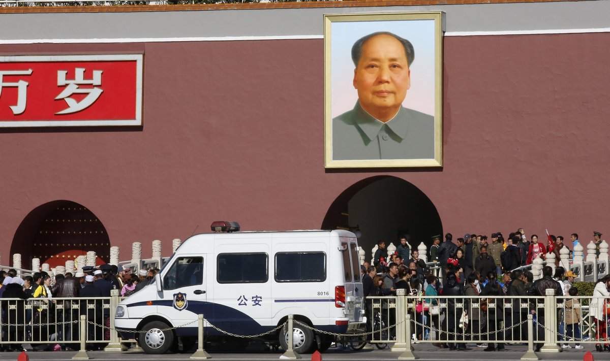 A police car is parked in front of the giant portrait of late Chinese Chairman Mao Zedong at the main entrance of the Forbidden City in Beijing