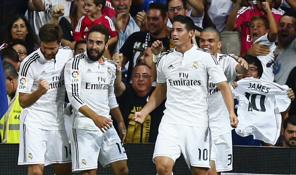 Real Madrid's James Rodriguez is congratulated by teammates after scoring a goal against Atletico Madrid during their Spanish Super Cup first leg soccer match in Madrid