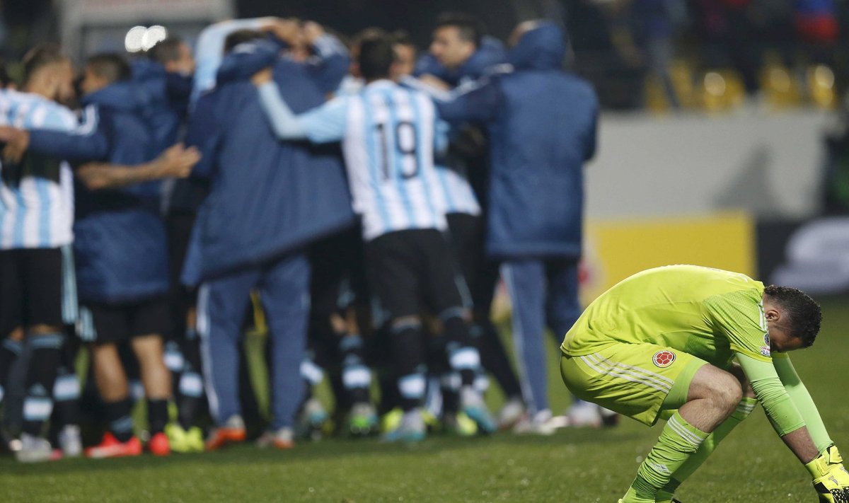 Colombia's goalie Ospina reacts as Argentina players celebrate their victory after penalty kicks in their Copa America 2015 quarter-finals soccer match at Estadio Sausalito in Vina del Mar