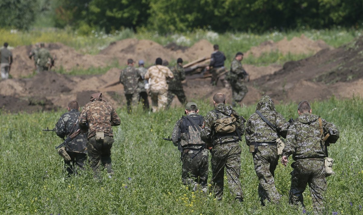Pro-Russian separatist fighters from the so-called Battalion Vostok (East) walk towards a checkpoint in Donetsk