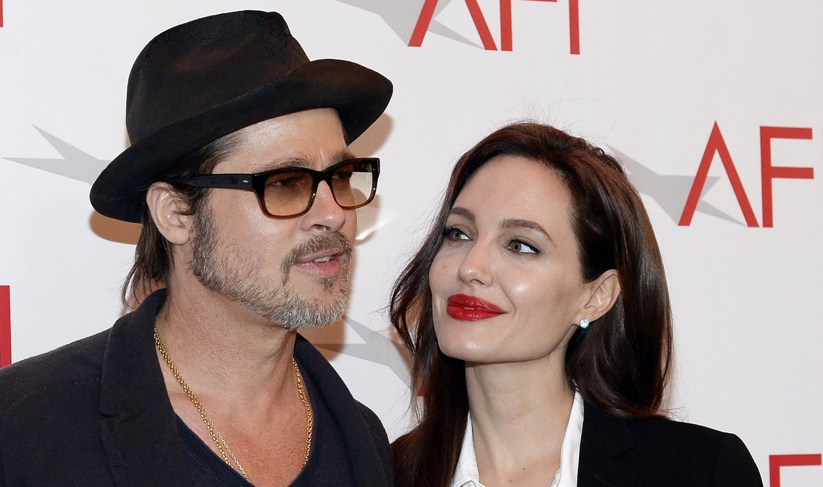 Actor Brad Pitt and actress/director Angelina Jolie pose at the AFI Awards 2014 honoring excellence in film and television in Beverly Hills