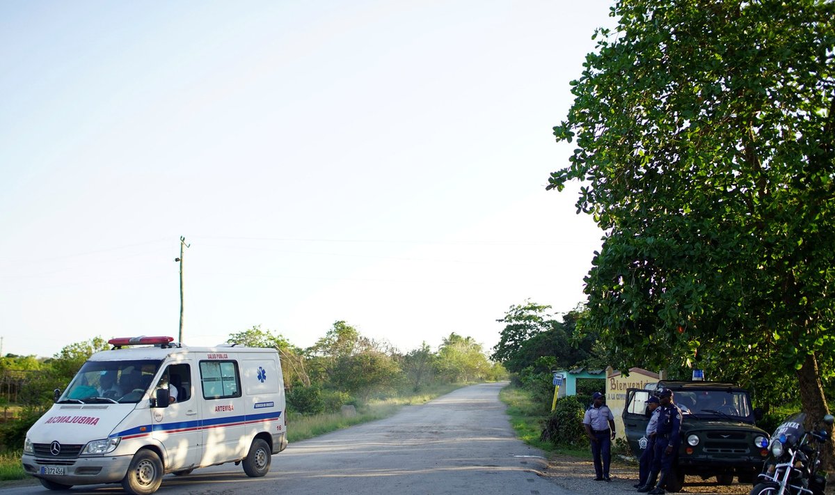 An ambulance leaves the area where a military plane crashed into a mountain in Carambola, Cuba