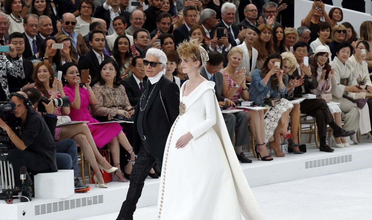 German designer Karl Lagerfeld and model Ashleigh Good appear at the end of his Haute Couture Fall/Winter 2014-2015 fashion show for French fashion house Chanel in Paris