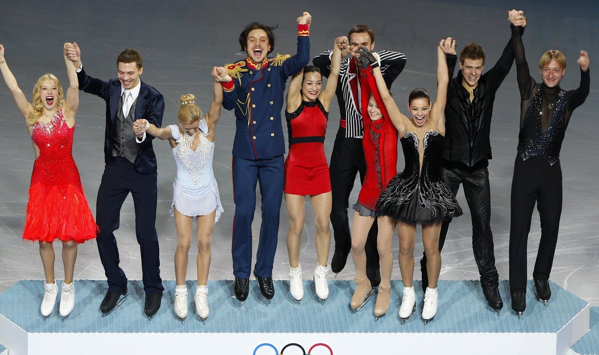 The Russian figure skating team steps onto the podium at the Sochi 2014 Winter Olympics