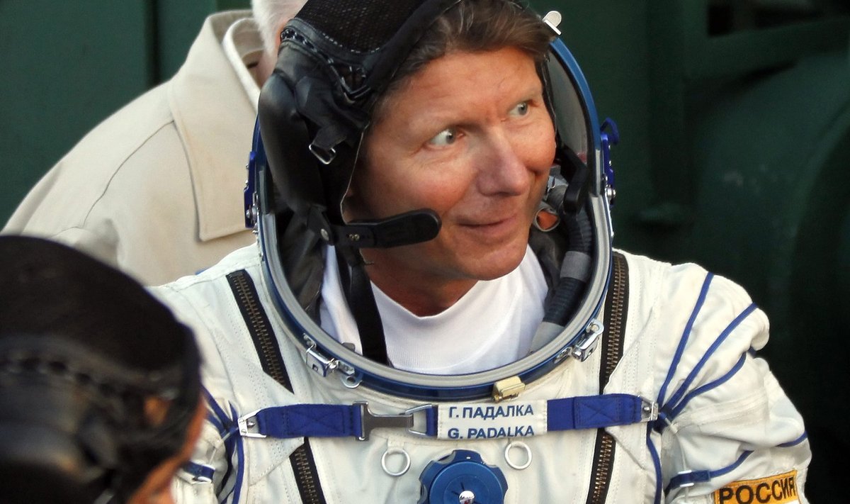 The International Space Station (ISS) crew member Russian cosmonaut Gennady Padalka waves as he boards the Soyuz TMA-04M spacecraft at Baikonur cosmodrome